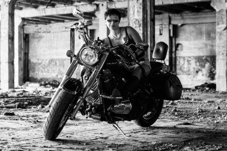 Strong independent , self-sufficient girl with male hobby on chopper motorcycle, international womens day concept.の写真素材