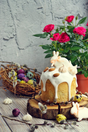 Easter cake with gingerbread in the form of a rabbit on the table, the table is decorated with...