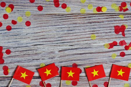 Independence Day of Vietnam concept with flag in hand on white wooden background top viewの写真素材