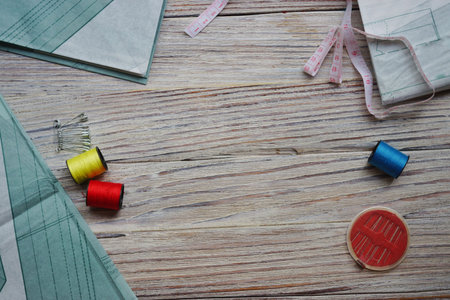 threads and needles on the background with patterns, accessories for cutting and sewing, womens...