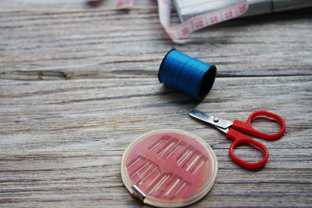 threads and needles on the background with patterns, accessories for cutting and sewing, womens...