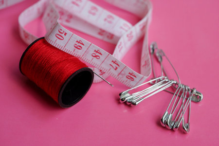 threads and needles on the background with patterns, accessories for cutting and sewing, womens...