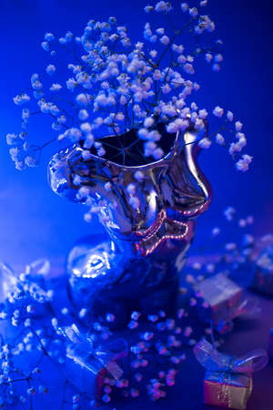 Aesthetics of Ancient Greece, bust with gift boxes of trendy lilac color in neon lighting. The concept of March 8 and Valentines Dayの写真素材