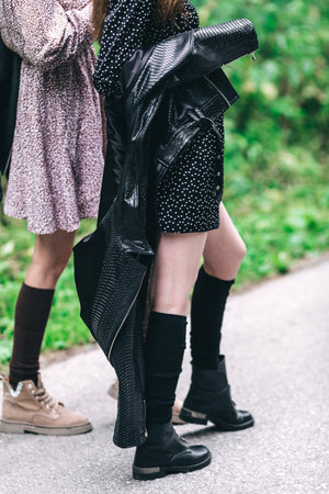 Two girls, blonde and brunette on the road in the summer forest. high quality photoの写真素材