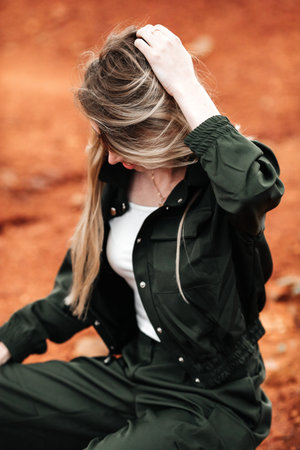 Girls in a post-apocalyptic place, a quarry with red earth and stones in work clothes. high quality...