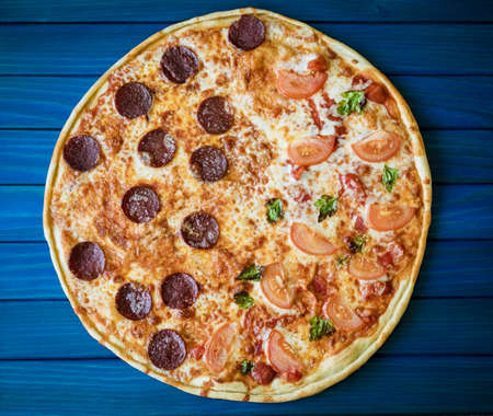 food cooking, culinary and people concept - cook or baker hand with pizza on peel at pizzeriaの写真素材