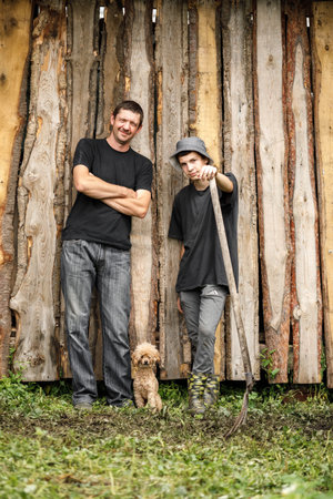 local agriculture, farmers day 12 october. a man in a black t-shirt with a pitchfork, natural products with his own hands.の写真素材