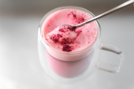 Double-walled glass thermocup with beetroot latte, pink latte is a fashionable and relevant alternative to coffee. giving up caffeine in favor of a healthy lifestyle. Rhinestones on the marmeshow.の写真素材