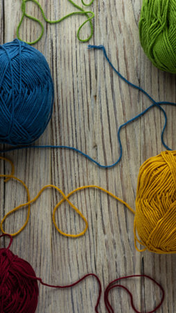 multi-colored threads for knitting and knitting needles. Selection of colorful wool yarn. Yarn for...