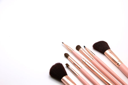Cosmetic set of make up brush on pink color isolated on a white background