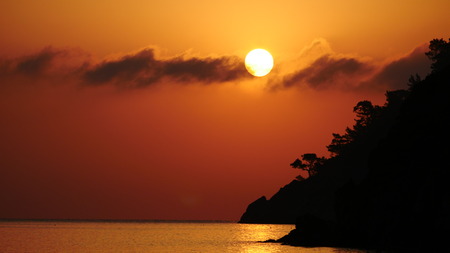 Sunrise silhouette above sea and sky Turkeyの写真素材