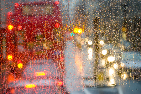 Rain in London view to red bus through rain-specked windowの写真素材