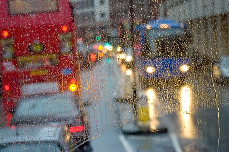 Rain in London view to red bus through rain-specked windowの写真素材