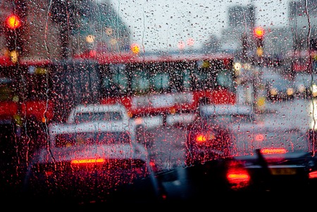 Rain in London view to red bus through rain-specked windowの写真素材