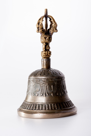 a bronze buddhist hand bell isolated over a white backgroundの写真素材