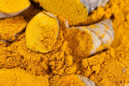 Turmeric roots with turmeric powder. Spice symbol. For food design, restaurant, store, market, health care products. Can be used as logo, price tag, labelの写真素材