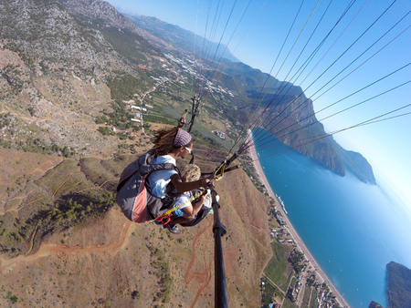 ADRASAN, TURKEY - JUNE 27, 2017: Paragliding fly above lagunaのeditorial素材