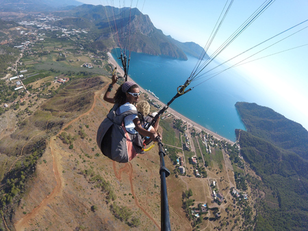 ADRASAN, TURKEY - JUNE 27, 2017: Paragliding fly above lagunaのeditorial素材