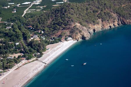 Pine tree with blue sea laguna paraglaiding background Turkeyの写真素材
