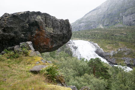 Waterfall in mountains of Norway in rainy weather.の写真素材