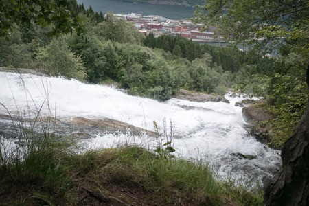 Waterfall in mountains of Norway in rainy weather.の写真素材