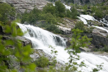 Waterfall in mountains of Norway in rainy weather.の写真素材