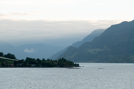 Fjord reflection in clear water in Norwayの写真素材