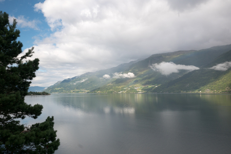 Fjord reflection in clear water in Norwayの写真素材