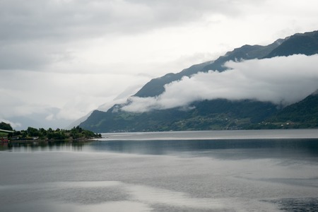 Fjord reflection in clear water in Norwayの写真素材