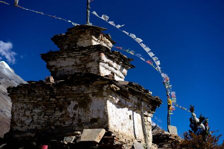 Buddhist stupa and lungta prayer flags in the Himalaya mountains, Annapurna region, Nepalの写真素材