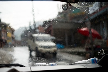 Blurred street scene through car windows with rain drop in Nepalの写真素材