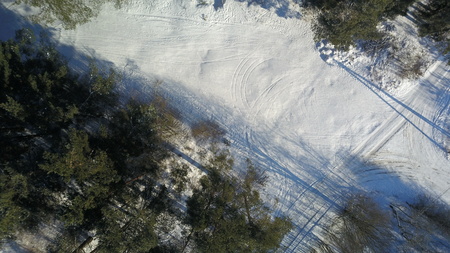 Aerial view of winter frozen forest covered in snowの写真素材