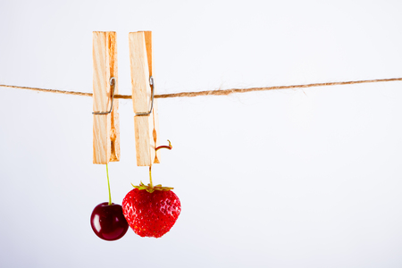 Cherry and rope on white with clampの写真素材