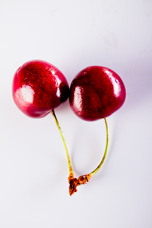 Cherry and rope on white with clampの写真素材