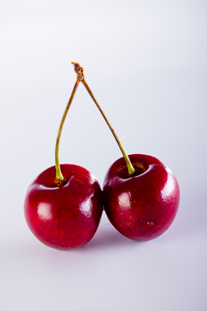 Cherry and rope on white with clampの写真素材