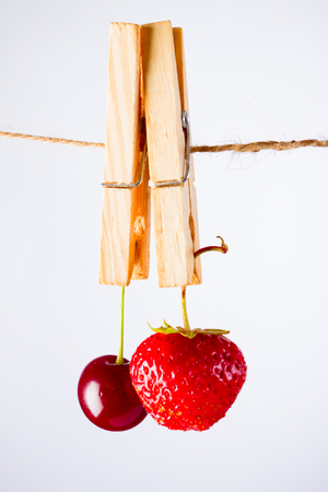 Cherry and rope on white background with clampの写真素材