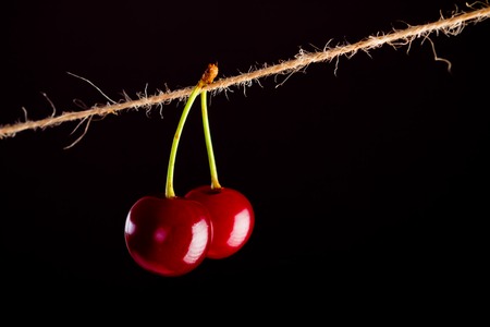 Cherry and rope on black with clampの写真素材