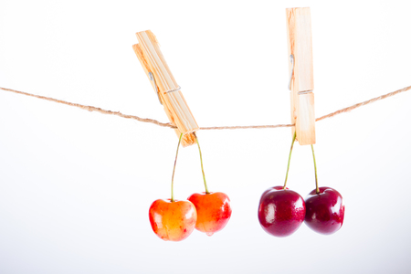 Cherry and rope on white background with clampの写真素材