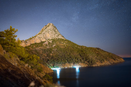 Night sky above sea and pine tree with blue sea background Turkeyの写真素材