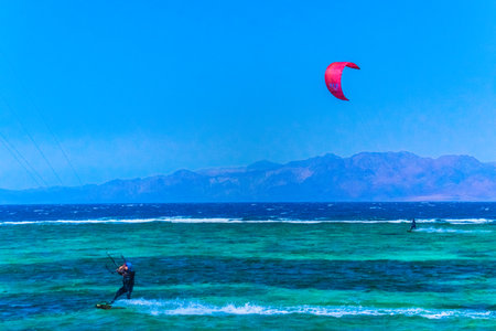 Kite surfing in Dahab Egypt. Exploring the blue water with mountainsの写真素材