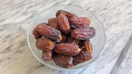 Dates fruit in glass bowlle table. Top view.