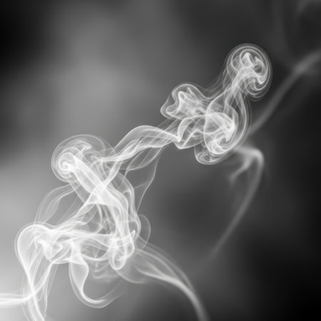 Wisps of white smoke gracefully curl and intertwine, creating an ethereal, abstract pattern against a dark, moody backdrop.の素材