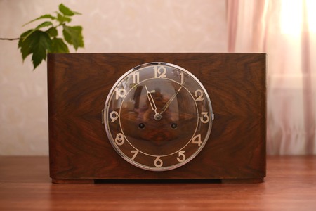 Vintage old table clock in wooden case with glass lidの写真素材