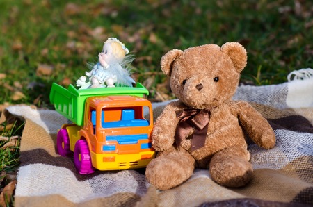 Toy brown Teddy bear and colorful toy car truckの写真素材