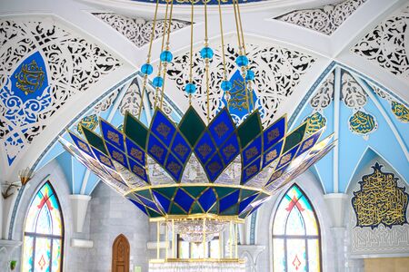 Beautiful ceiling painted with Arabic inscriptions and ornaments with a large blue and white chandelier in the mosque Kul Sharif in Kazanのeditorial素材