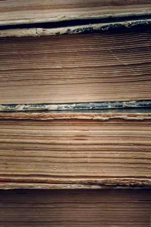 Frayed, yellowed, dark pages of old books closeupの写真素材