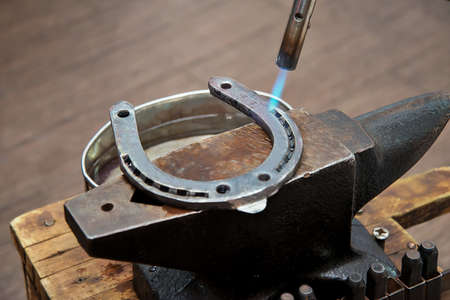 Manufacturing of metal horseshoes on the machine with gas burnerの写真素材