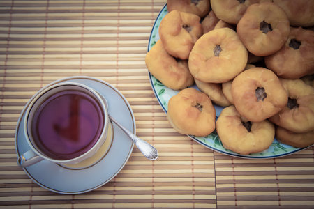 Hot tea in a cup with a saucer and tatar meat pies, peremyachの写真素材