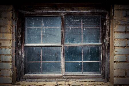 Dirty window in the old house shedの写真素材