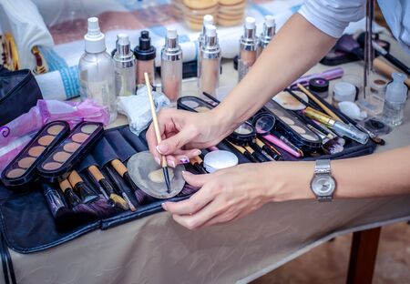 Hand worked as a makeup artist working with makeup brushの写真素材
